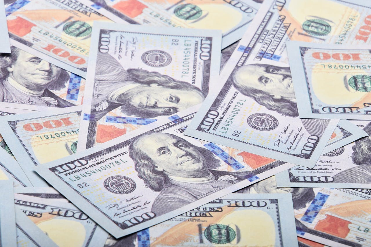 A detailed close-up shot of multiple US dollar bills spread out, showcasing currency detail.